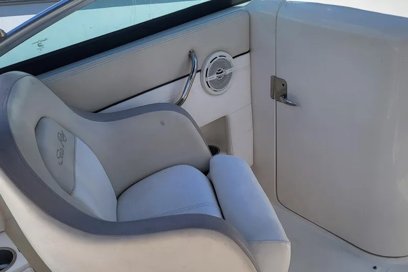 Slide: The Image of 2013 Sea Ray 260 Sundeck interior with white seating and speaker detail. - 20