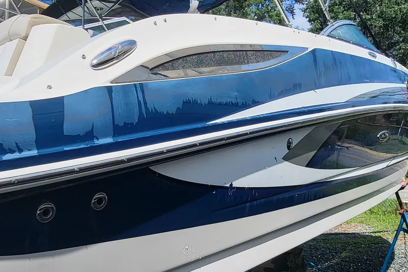 Slide: The Image of 2013 Sea Ray 260 Sundeck boat with sleek blue and white design. - 3