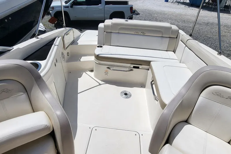 Slide: The Image of 2013 Sea Ray 260 Sundeck interior with white seating and spacious layout. - 7