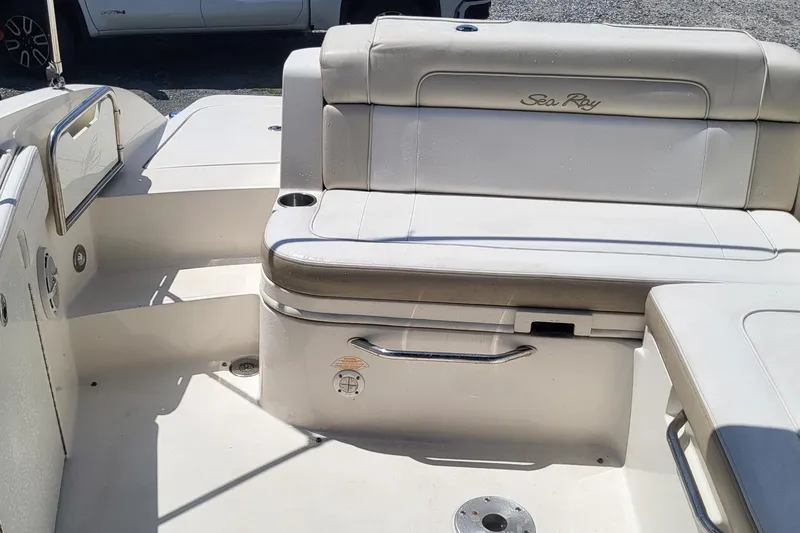 Slide: The Image of 2013 Sea Ray 260 Sundeck interior with beige seating and stainless steel accents. - 8
