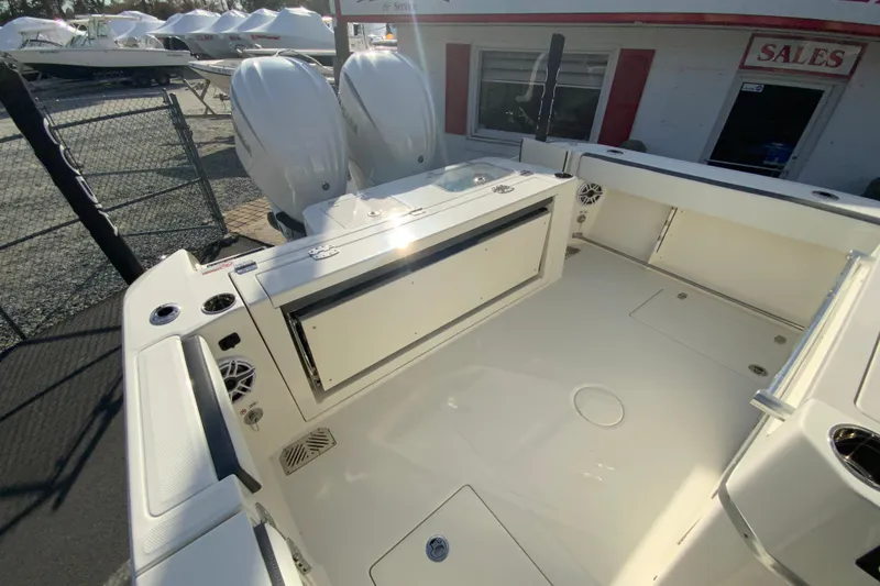 Slide: The Image of 2026 Cobia 285 Center Console boat with dual engines, spacious deck, and modern features. - 14
