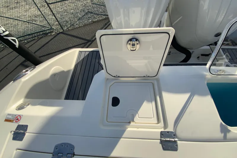 Slide: The Image of 2026 Cobia 285 Center Console boat deck with open storage compartment. - 16