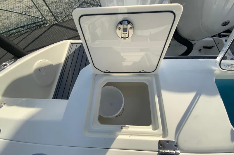 Slide: The Image of 2026 Cobia 285 Center Console boat with open storage compartment on deck. - 17