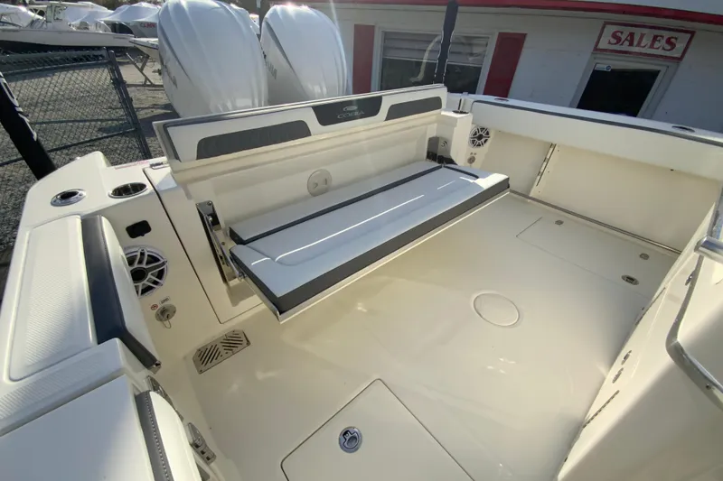 Slide: The Image of 2026 Cobia 285 Center Console boat interior with foldable seating and twin engines. - 18
