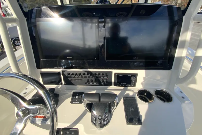 Slide: The Image of 2026 Cobia 285 Center Console dashboard with dual Garmin displays and control panel. - 22
