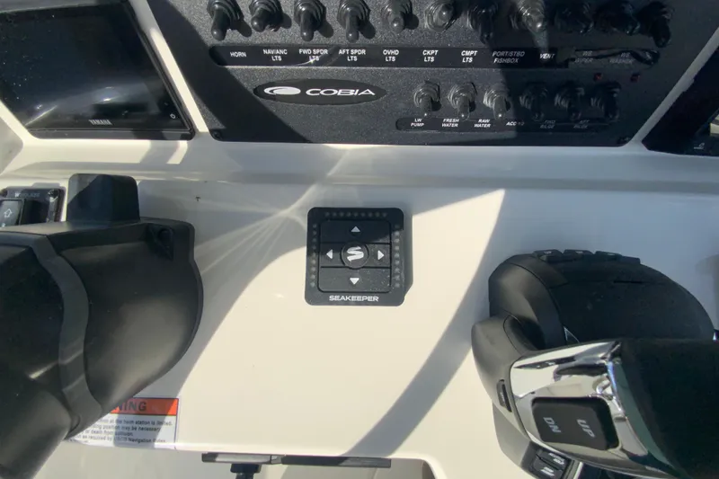 Slide: The Image of 2026 Cobia 285 Center Console dashboard with controls and Seakeeper system. - 23