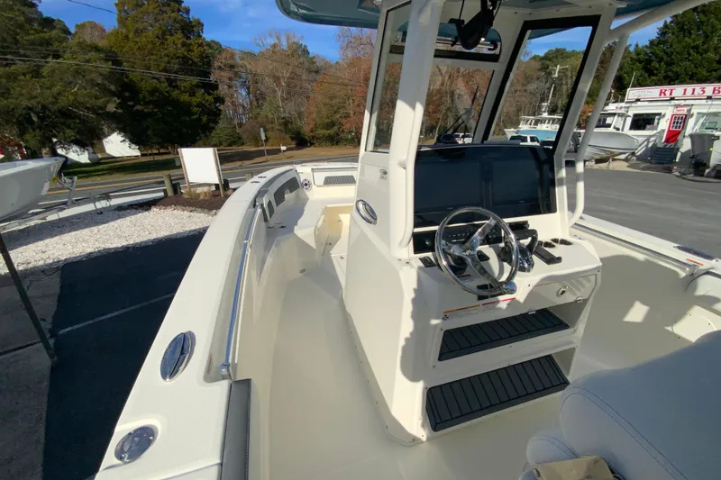 Slide: The Image of 2026 Cobia 285 Center Console boat with modern helm and spacious deck. - 28