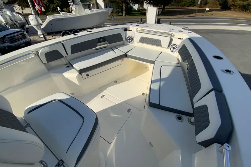 Slide: The Image of 2026 Cobia 285 Center Console boat interior with cushioned seating and storage compartments. - 32