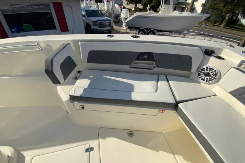 Slide: The Image of 2026 Cobia 285 Center Console boat interior with cushioned seating and speaker. - 33
