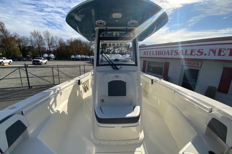Slide: The Image of 2026 Cobia 285 Center Console boat at dealership, sunny day. - 36