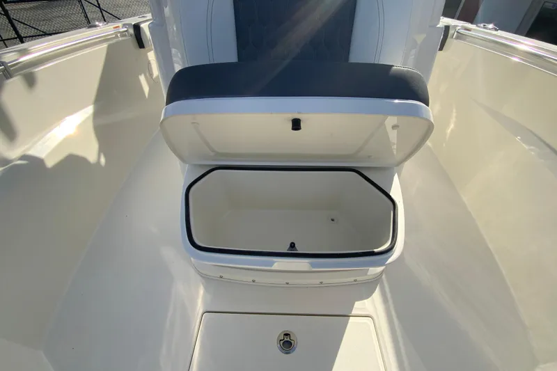 Slide: The Image of 2026 Cobia 285 Center Console boat with open storage compartment. - 38
