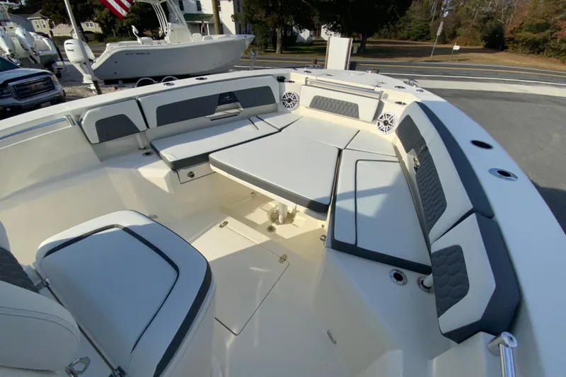 Slide: The Image of 2026 Cobia 285 Center Console boat interior with cushioned seating and table. - 41