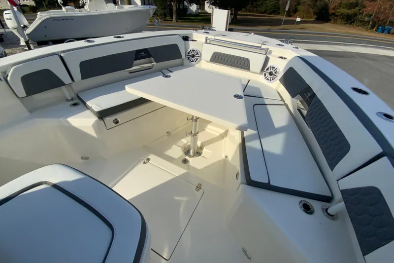 Slide: The Image of 2026 Cobia 285 Center Console boat interior with seating and table. - 42
