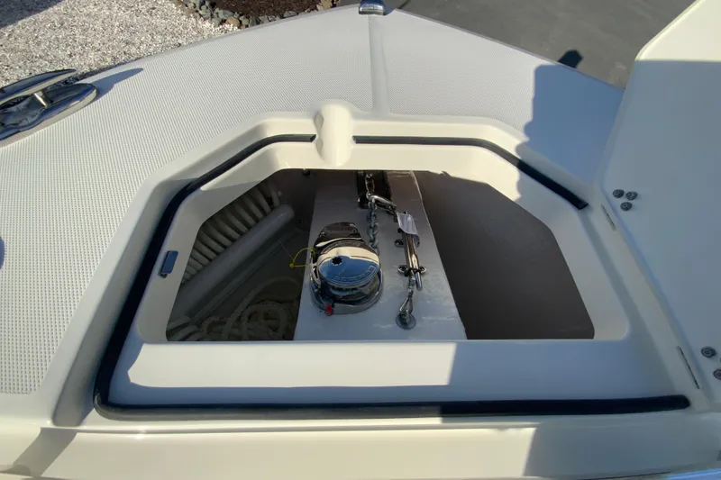 Slide: The Image of 2026 Cobia 285 Center Console anchor storage compartment with chain and rope. - 43
