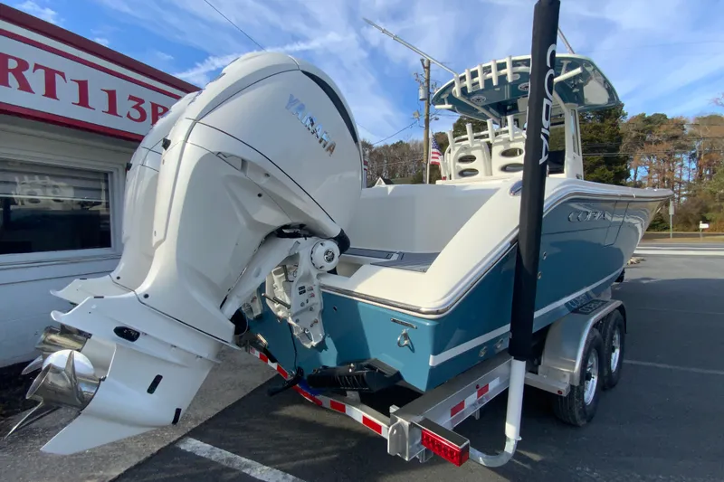 Slide: The Image of 2026 Cobia 285 Center Console boat with Yamaha outboard engine on a trailer. - 9