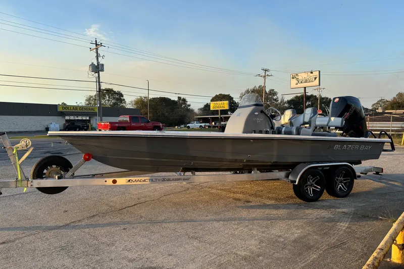 The Image of 2026 Blazer Bay 675 Ultimate Bay boat on trailer in parking lot. - 1