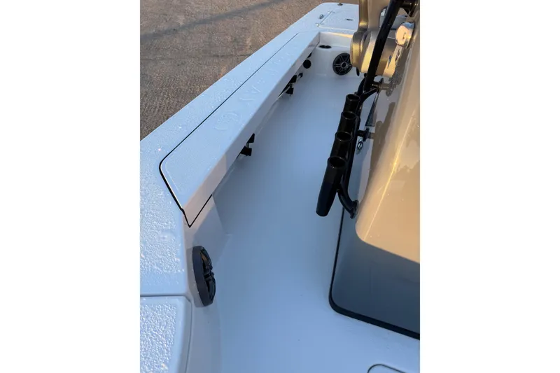 Slide: The Image of 2026 Blazer Bay 675 Ultimate Bay boat interior with rod holders and storage compartments. - 11