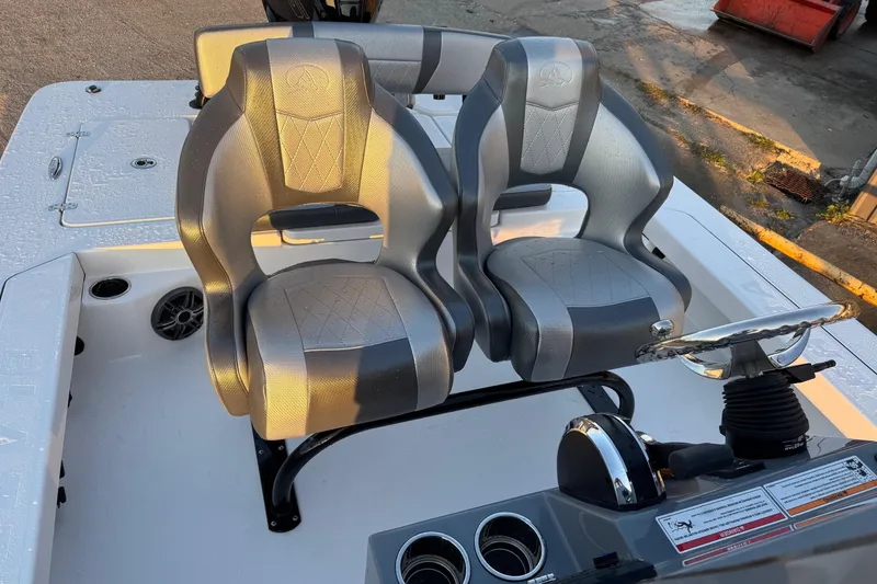 Slide: The Image of 2026 Blazer Bay 675 Ultimate Bay boat seats and steering console in sunlight. - 12