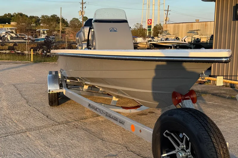 Slide: The Image of 2026 Blazer Bay 675 Ultimate Bay boat on trailer in outdoor setting. - 5