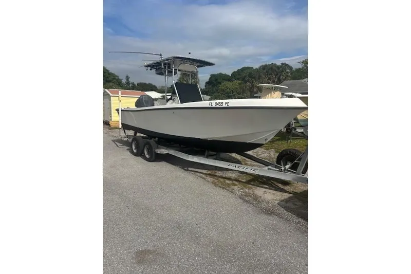 The Image of 1998 Mako 221 Center Console boat on trailer, parked outdoors. - 0