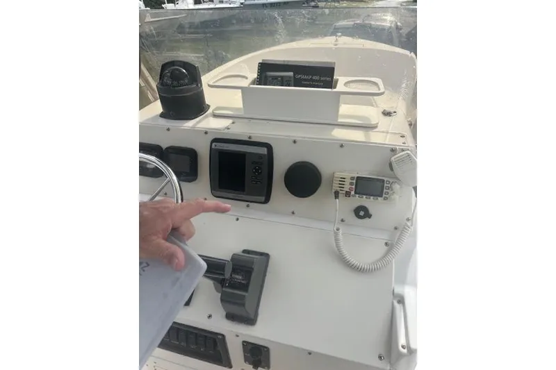 Slide: The Image of 1998 Mako 221 Center Console boat dashboard with navigation and communication equipment. - 10