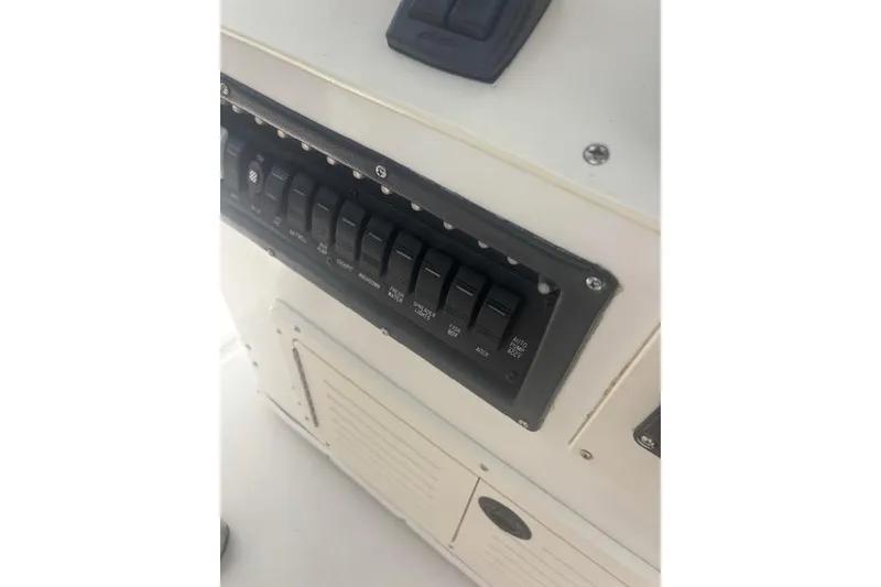 Slide: The Image of 1998 Mako 221 Center Console boat control panel with switches. - 11