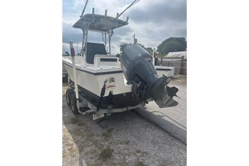 Slide: The Image of 1998 Mako 221 Center Console boat with outboard motor on trailer. - 3