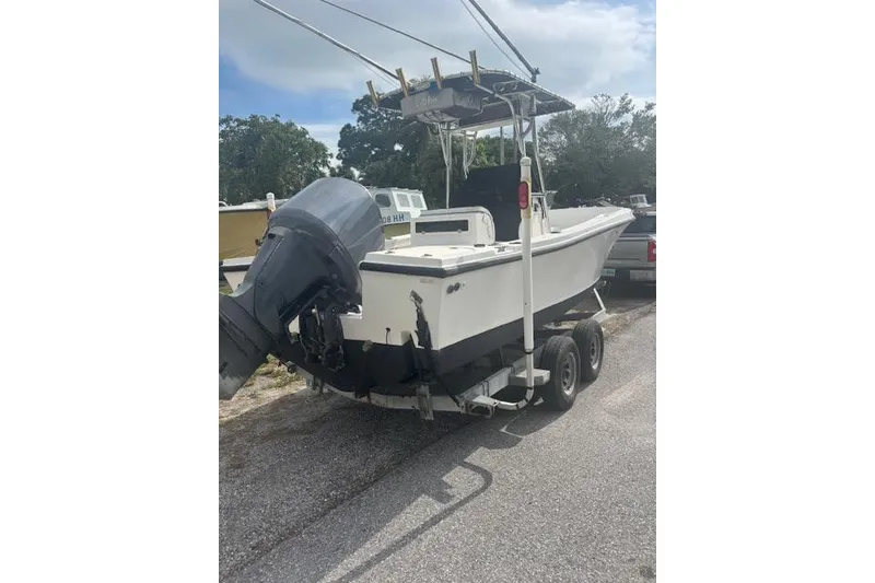 Slide: The Image of 1998 Mako 221 Center Console boat on trailer with outboard motor, parked outdoors. - 5
