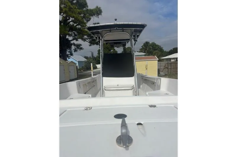 Slide: The Image of 1998 Mako 221 Center Console boat with T-top, docked outdoors. - 6