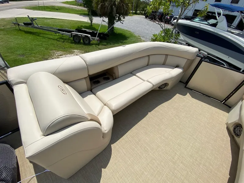 Slide: The Image of Luxurious seating on 2021 Harris 250 Cruiser pontoon boat, featuring beige upholstery and spacious layout. - 11