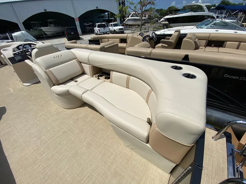 Slide: The Image of Luxurious seating on a 2021 Harris 250 Cruiser pontoon boat, featuring beige upholstery. - 4