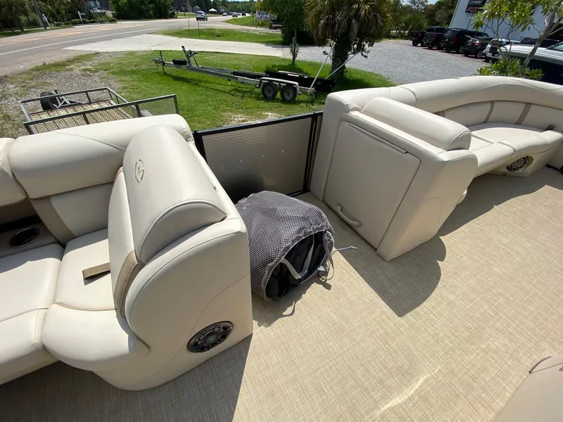 Slide: The Image of 2021 Harris 250 Cruiser interior with beige seating and outdoor view. - 8
