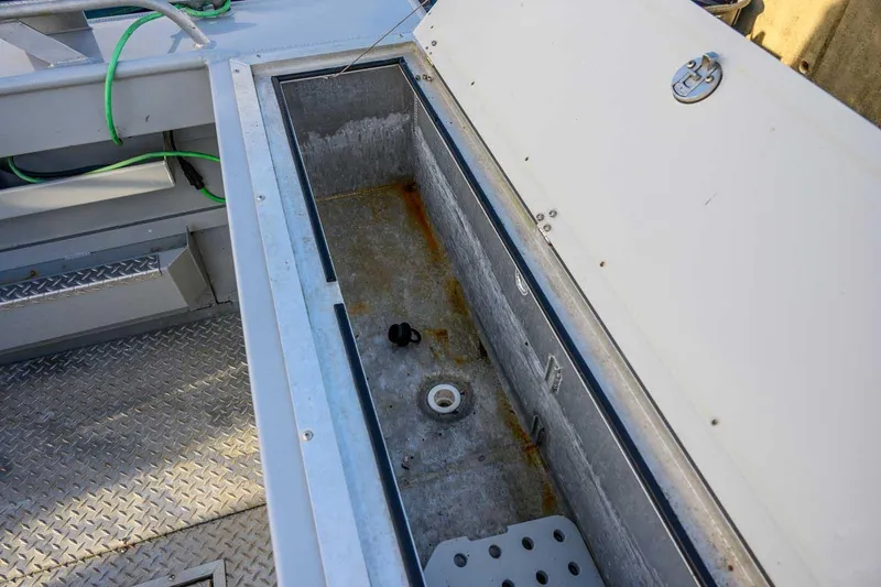 Slide: The Image of Open storage compartment on 2017 Hewescraft 240 Ocean Pro boat deck. - 11