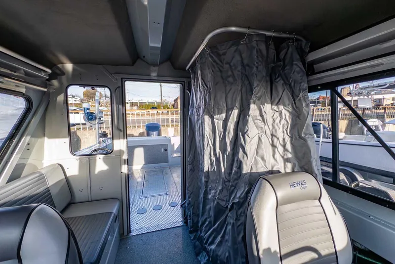 Slide: The Image of Interior of 2017 Hewescraft 240 Ocean Pro boat with seating and curtain. - 26