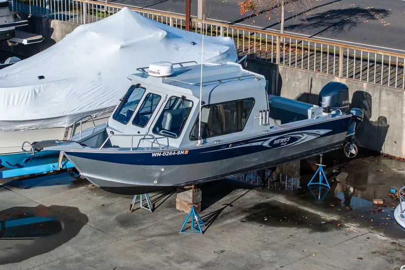 Slide: The Image of 2017 Hewescraft 240 Ocean Pro boat on stands in a marina. - 28