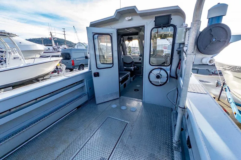 Slide: The Image of 2017 Hewescraft 240 Ocean Pro boat interior with open cabin door and visible seating. - 8