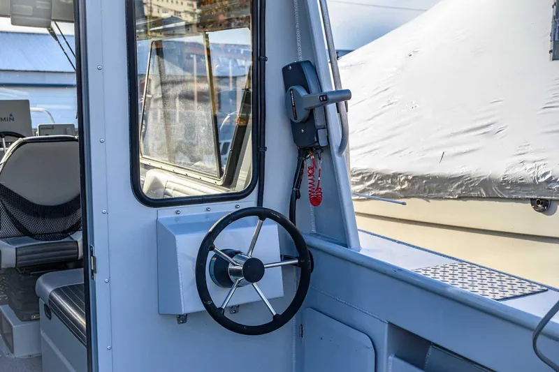 Slide: The Image of 2017 Hewescraft 240 Ocean Pro boat interior with steering wheel and controls. - 9