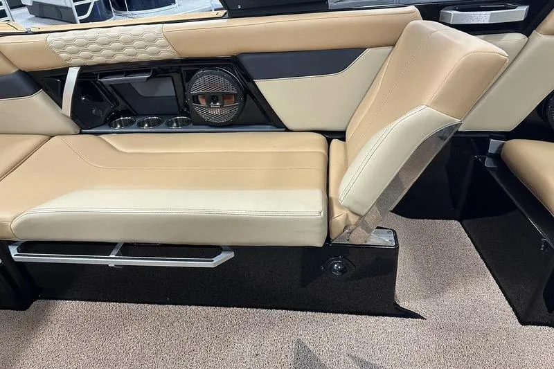 Slide: The Image of 2025 MasterCraft XT24 interior with beige leather seating and integrated speaker system. - 13
