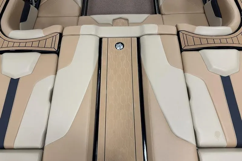 Slide: The Image of 2025 MasterCraft XT24 boat interior with beige and black seating design. - 15