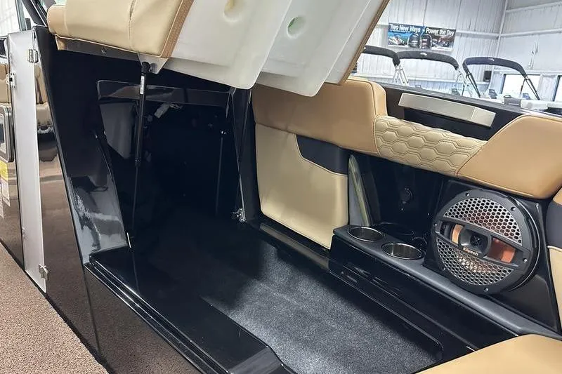 Slide: The Image of 2025 MasterCraft XT24 interior with storage, cup holders, and speaker system. - 3