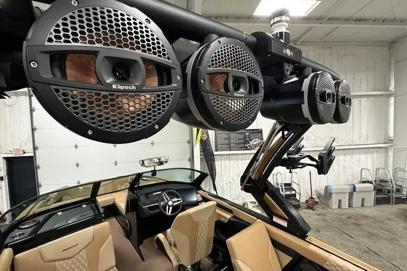 Slide: The Image of 2025 MasterCraft XT24 boat interior with Klipsch speakers and luxury seating. - 32