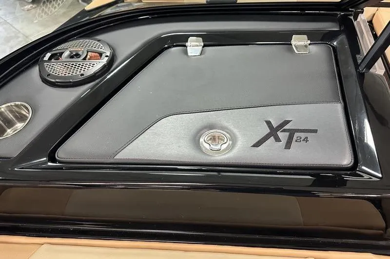 Slide: The Image of 2025 MasterCraft XT24 boat interior detail with speaker and storage compartment. - 35