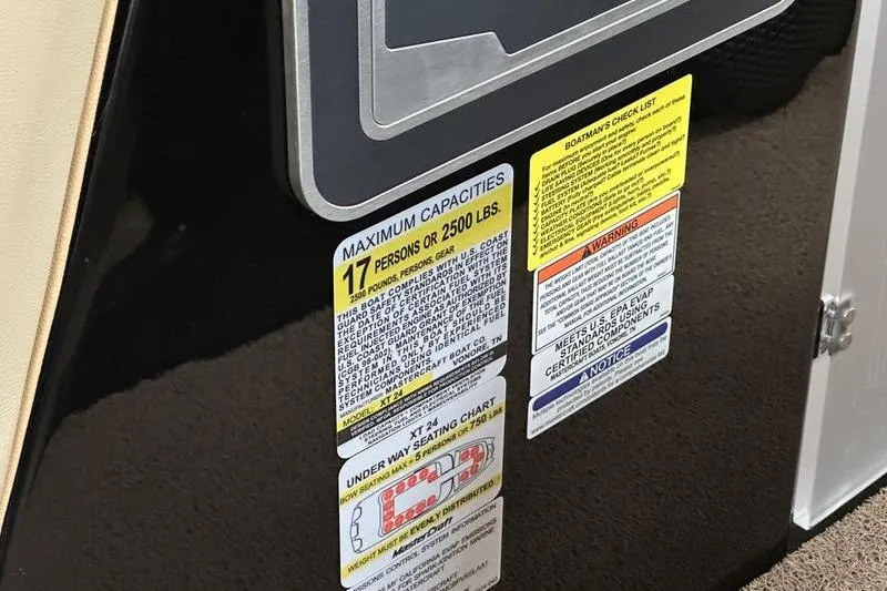 Slide: The Image of 2025 MasterCraft XT24 capacity label, seating chart, and safety warnings. - 48