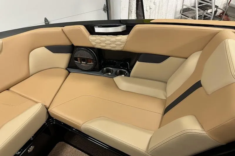 Slide: The Image of 2025 MasterCraft XT24 interior with tan leather seating and built-in speakers. - 50