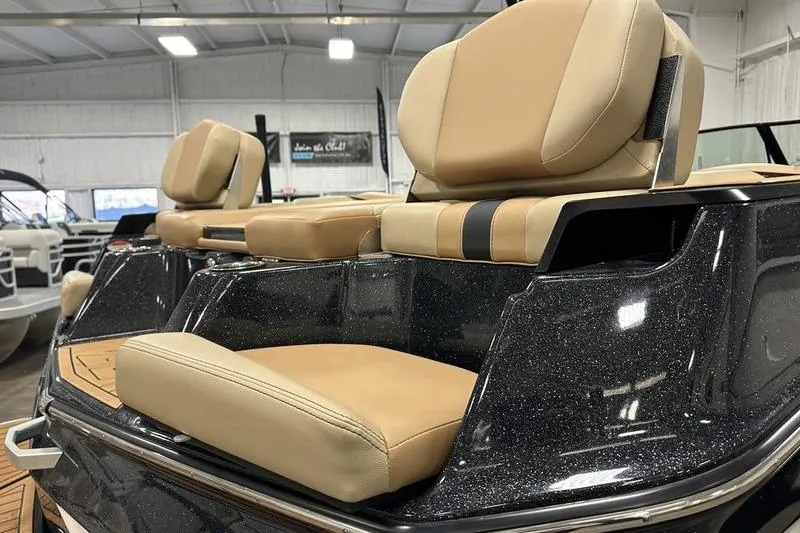 Slide: The Image of 2025 MasterCraft XT24 boat interior with luxurious tan seating and sleek design. - 7