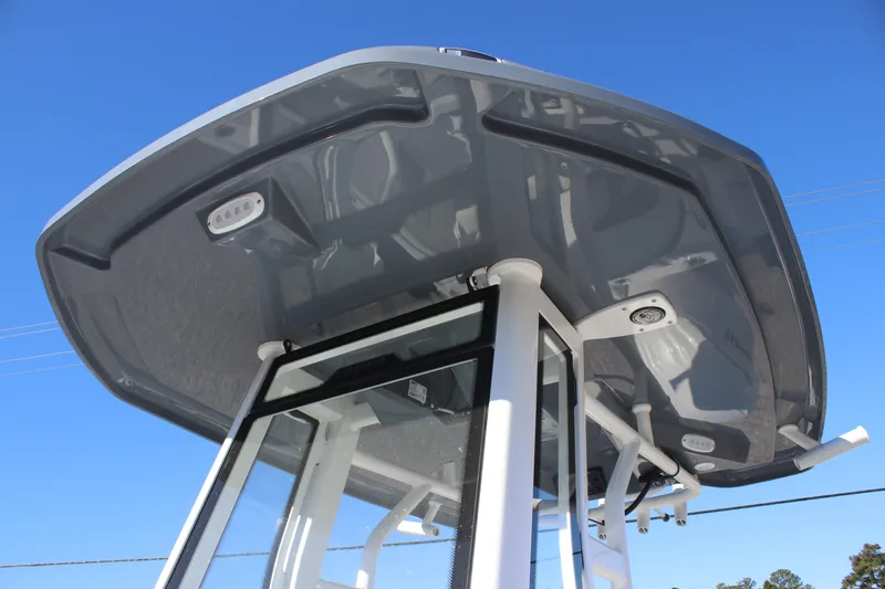 Slide: The Image of Tidewater 232 CC Adventure 2026 boat's T-top against clear blue sky. - 14