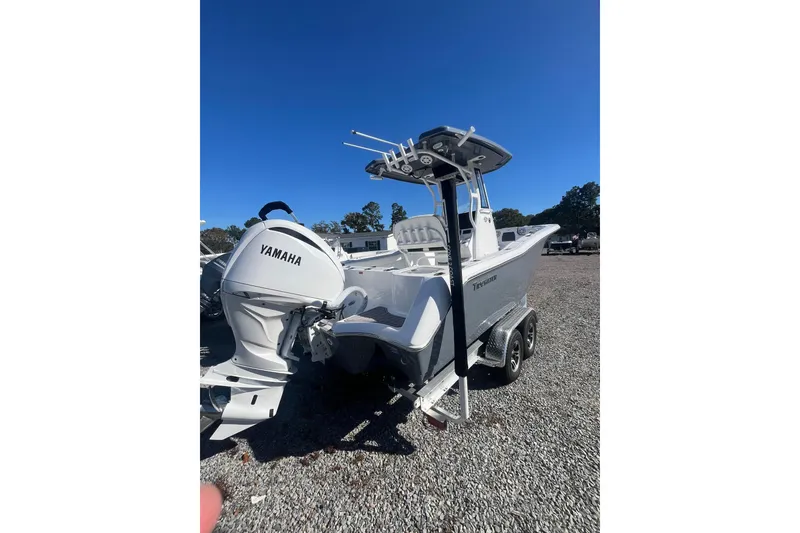 Slide: The Image of 2026 Tidewater 232 CC Adventure boat on trailer, side view, outdoors. - 2