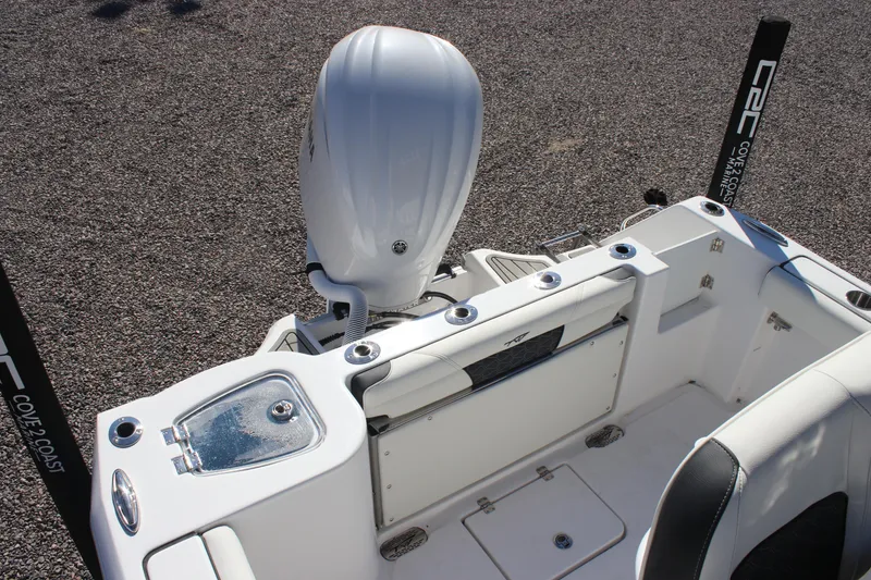 Slide: The Image of 2026 Tidewater 232 CC Adventure boat interior with engine and seating area. - 20