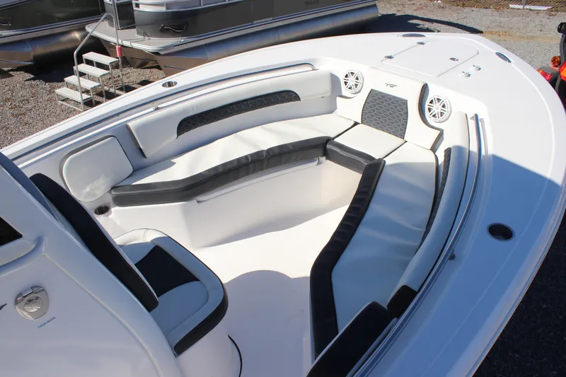 Slide: The Image of 2026 Tidewater 232 CC Adventure boat interior with cushioned seating and speakers. - 22