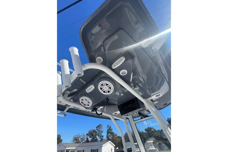 Slide: The Image of 2026 Tidewater 232 CC Adventure boat on trailer, side view, outdoors. - 7